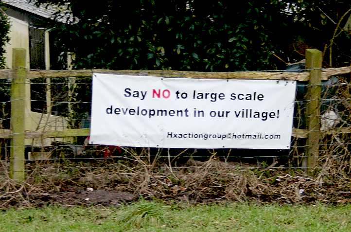 Protestors sign objecting to 70 house application